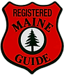 A red and black logo for the registered maine guide.