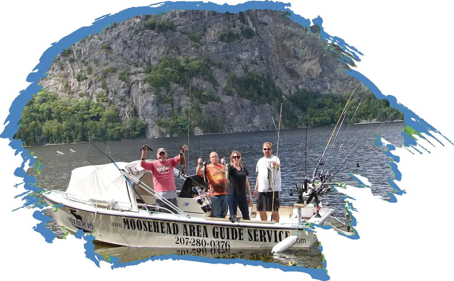 Friend Fishing Fishing charter boat on Moosehead Lake in front of mount kineo group of people holding up their fish on a fishing boat