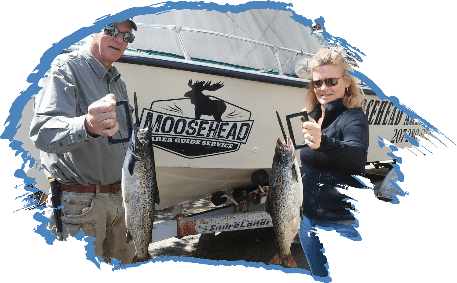 Couple holding their trophy salmon up from fishing on Moosehead Lake