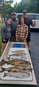 Family fishing charter catch from a Moosehead Lake Fishing Charter in Greenville Maine