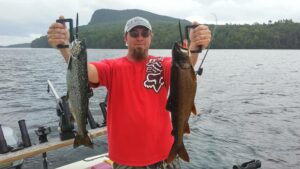 Guest holding a on a Lake Tour and Salmon on a fishing charter in Moosehead Lake Maine