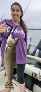 Woman holding up her fish caught on a Moosehead Lake Fishing Charter