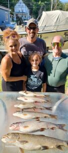 Family with fish caught on a fishing charter in Moosehead Lake Maine