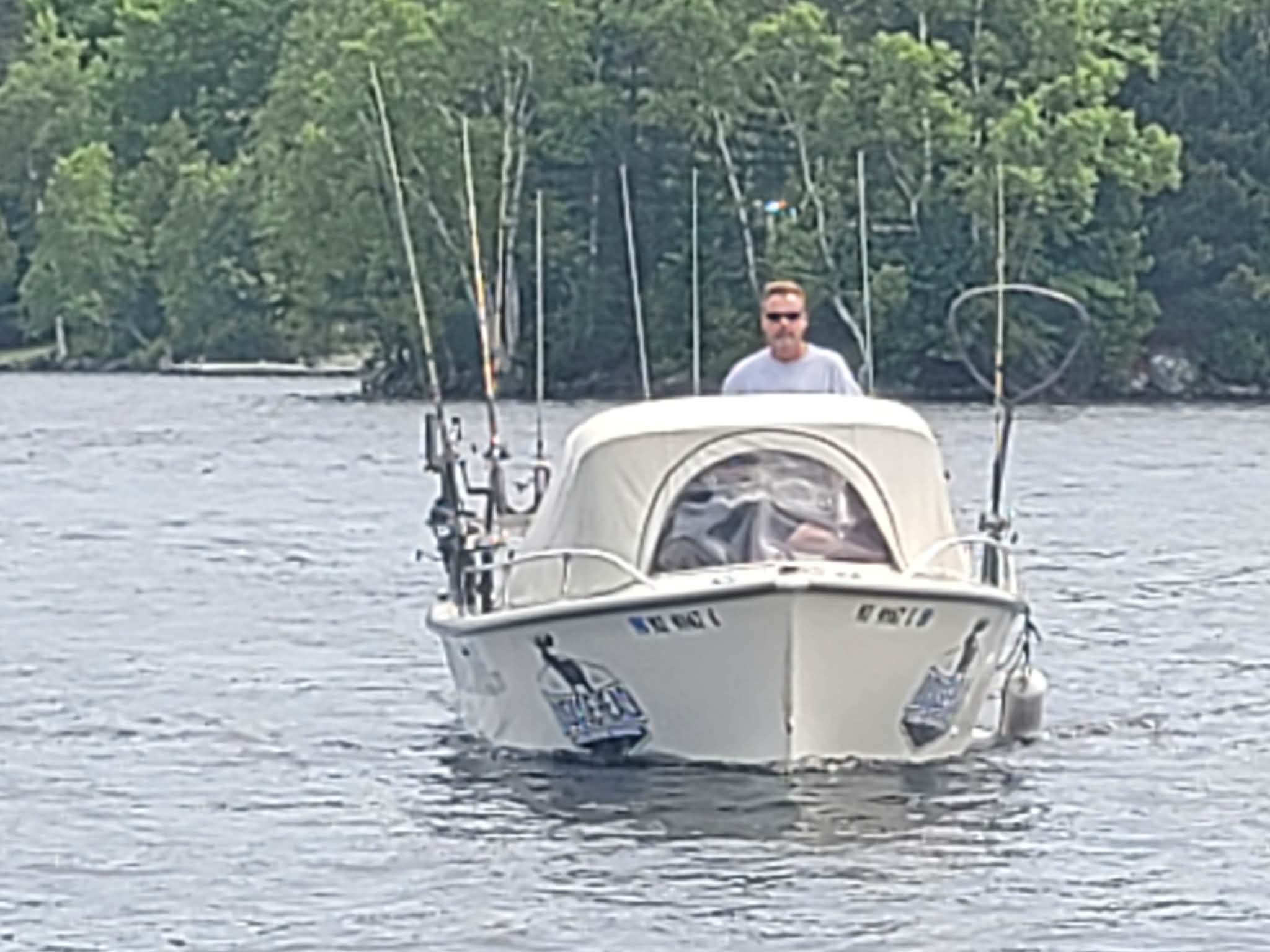 Fishing Guide Driving his boat on Moosehead Lake Fishing Charters